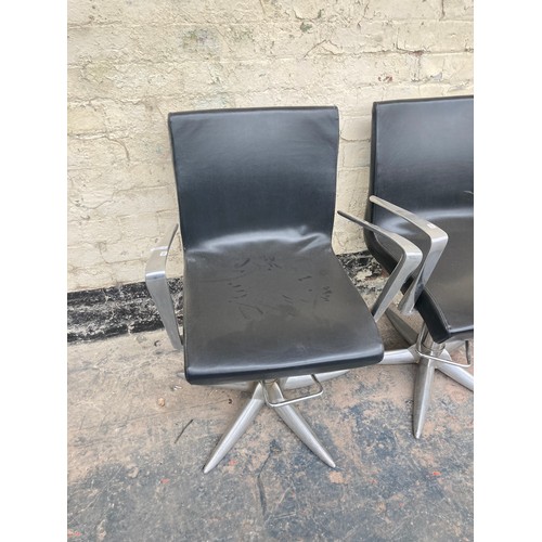 1231 - Four contemporary black leatherette salon chairs on metal supports