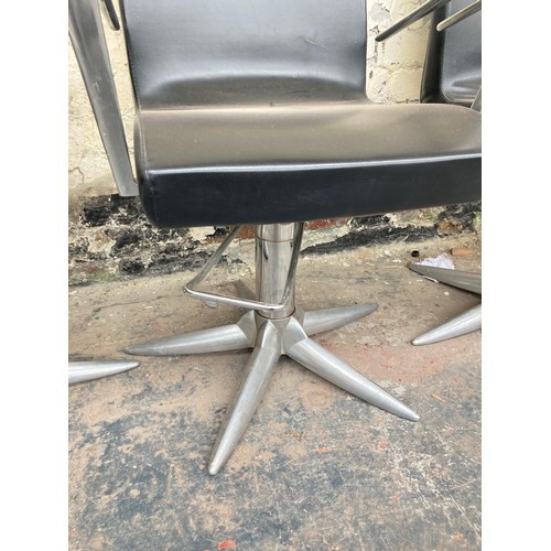 1231 - Four contemporary black leatherette salon chairs on metal supports