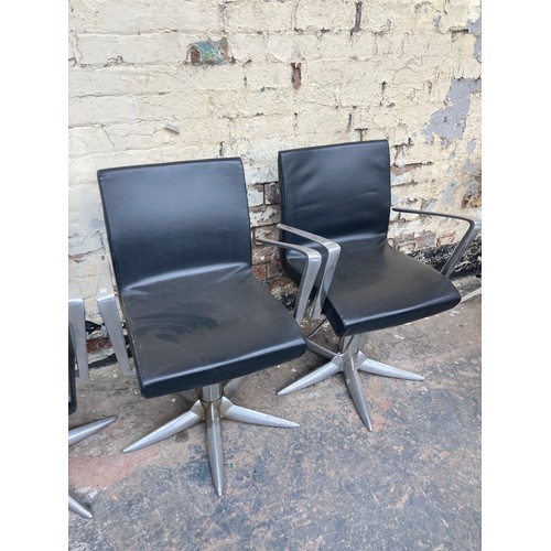 1231 - Four contemporary black leatherette salon chairs on metal supports