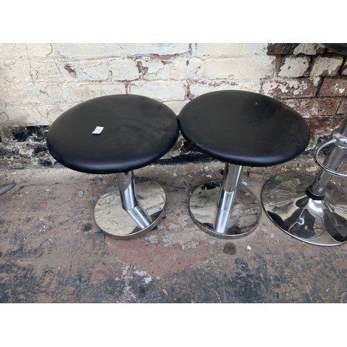 1231A - Five contemporary stools, four black leatherette low stools and one black plastic kitchen bar stool