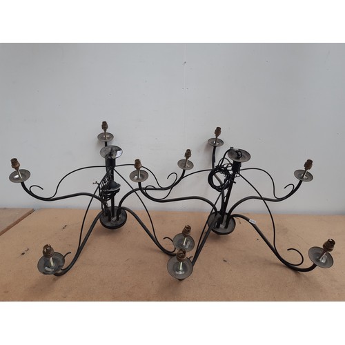 1188B - A pair of modern black metal five branch chandeliers