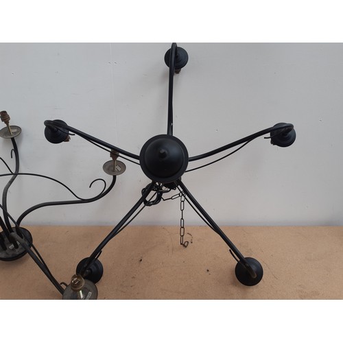 1188B - A pair of modern black metal five branch chandeliers