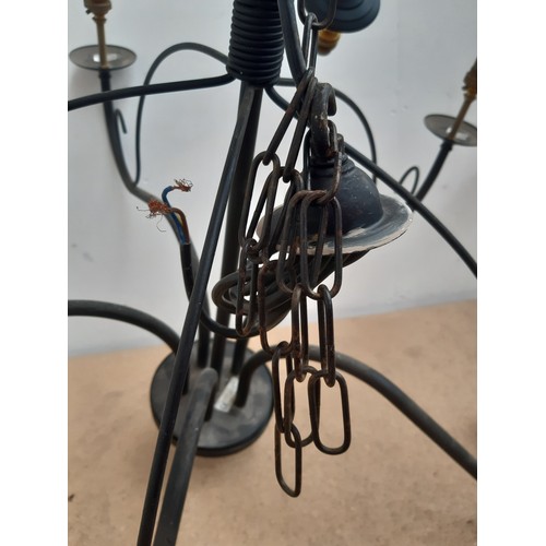 1188B - A pair of modern black metal five branch chandeliers