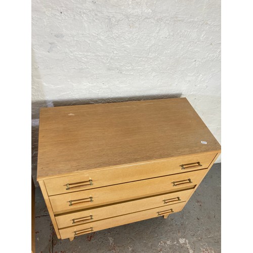 1028A - A mid 20th century oak effect two piece bedroom suite comprising chest of four drawers - approx. 81c... 