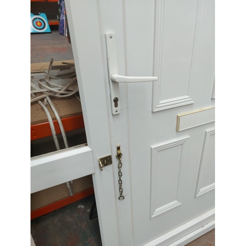 1279A - A modern white PVC front door with frame, glass and seals