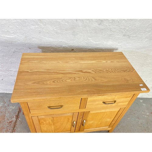 1056A - A modern oak sideboard with two drawers and two lower cupboard doors - approx. 83cm high x 94cm wide... 