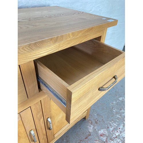 1056A - A modern oak sideboard with two drawers and two lower cupboard doors - approx. 83cm high x 94cm wide... 