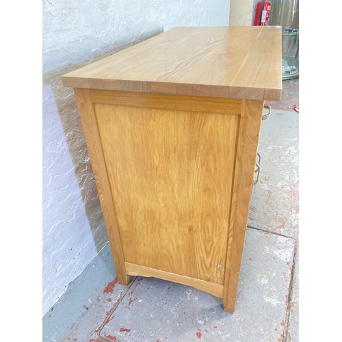 1056A - A modern oak sideboard with two drawers and two lower cupboard doors - approx. 83cm high x 94cm wide... 