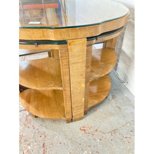 1032A - A vintage walnut serpentine coffee table with glass top and four nesting side tables with glass tops... 