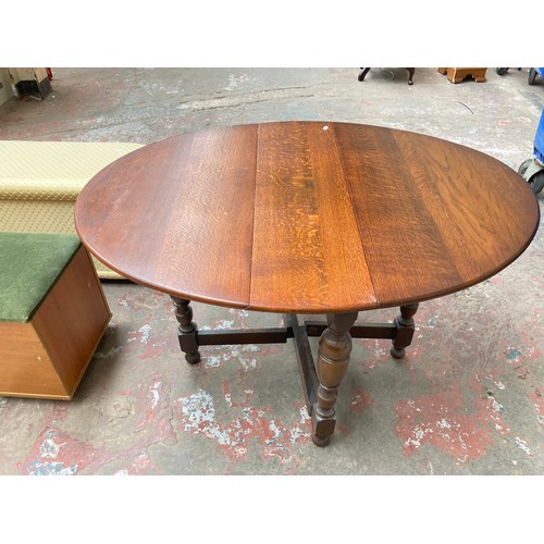 1047A - Six assorted pieces of furniture, oak drop leaf gate leg dining table, oak side table, brown rug, te... 