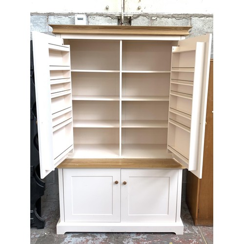 1092A - A modern oak and off white painted housekeepers/larder cupboard with two lower drawers, two upper do... 