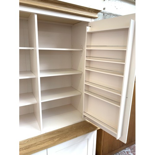 1092A - A modern oak and off white painted housekeepers/larder cupboard with two lower drawers, two upper do... 