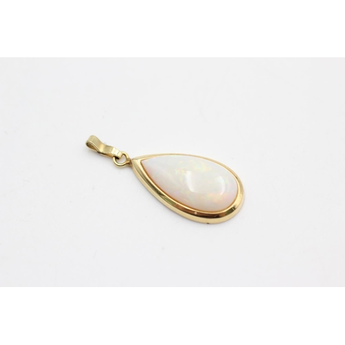 34 - Two 9ct gold pendants, one teardrop opal and one swivel aurora crystal - approx. gross weight 3.2 gr... 