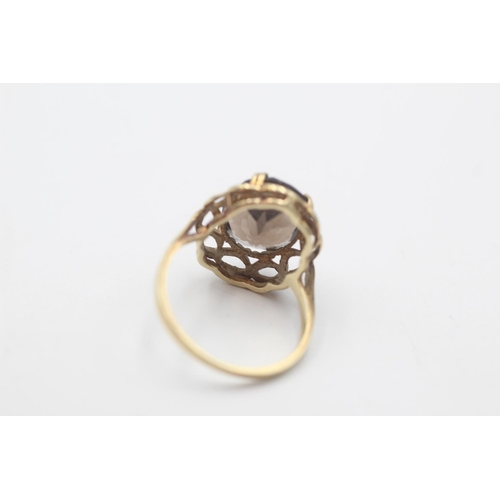 55 - A hallmarked Sheffield 9ct gold smoky quartz twisted frame cocktail ring, size P - approx. gross wei... 