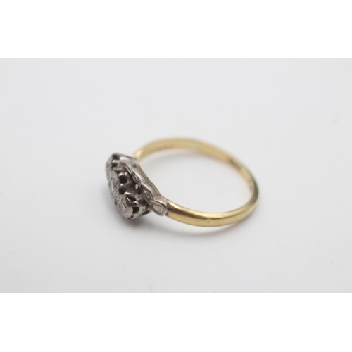 64 - An 18ct gold and platinum diamond trilogy ring, size M - approx. gross weight 2.5 grams