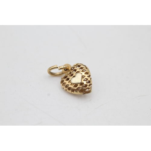 8 - An 18ct gold garnet set openwork heart pendant - approx. gross weight 1.2 grams