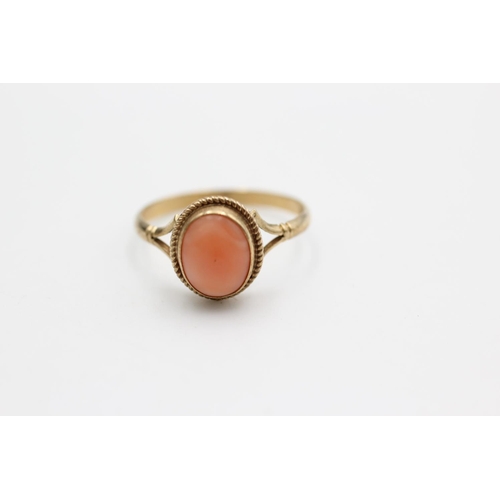 85 - A 9ct gold coral bordered solitaire dress ring, size N - approx. gross weight 1.5 grams