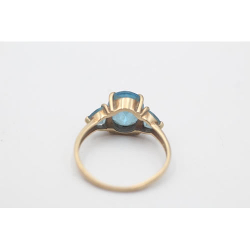 94 - A 9ct gold topaz three stone dress ring, size P½ - approx. gross weight 2.5 grams