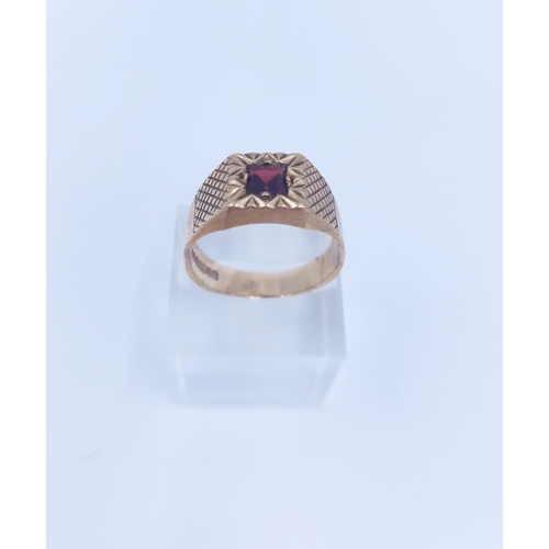 107 - A hallmarked Birmingham 9ct gold garnet signet ring, size V - approx. gross weight 5.76 grams