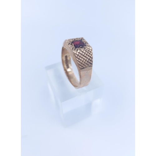 107 - A hallmarked Birmingham 9ct gold garnet signet ring, size V - approx. gross weight 5.76 grams