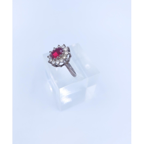 109 - A stamped silver red and clear gemstone floral cluster ring, size J - approx. gross weight 2.18 gram... 