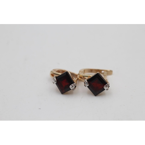 11 - A 9ct gold garnet and diamond French clip earrings and pendant set - approx. gross weight 6.6 grams