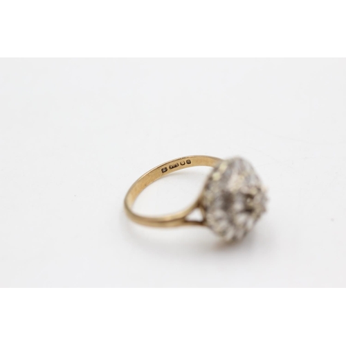 12 - A hallmarked London 9ct two tone gold diamond cluster ring, size K½ - approx. gross weight 3.5 grams