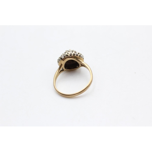 12 - A hallmarked London 9ct two tone gold diamond cluster ring, size K½ - approx. gross weight 3.5 grams