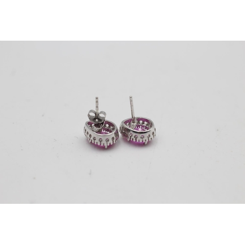 16 - A pair of 9ct white gold diamond and synthetic pink sapphire stud earrings - approx. gross weight 2.... 