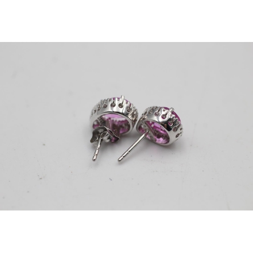 16 - A pair of 9ct white gold diamond and synthetic pink sapphire stud earrings - approx. gross weight 2.... 