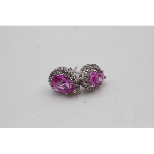 16 - A pair of 9ct white gold diamond and synthetic pink sapphire stud earrings - approx. gross weight 2.... 