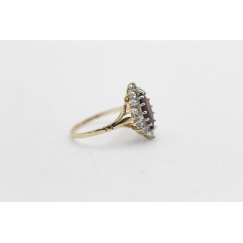 52 - A hallmarked Birmingham 9ct gold garnet and clear gemstone halo ring ,size R - approx. gross weight ... 