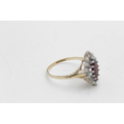 52 - A hallmarked Birmingham 9ct gold garnet and clear gemstone halo ring ,size R - approx. gross weight ... 