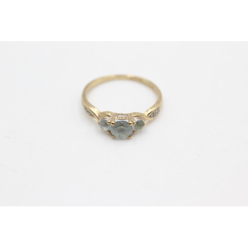 70 - A 9ct gold topaz three stone ring with diamond accents, size N½ - approx. gross weight 1.7 grams