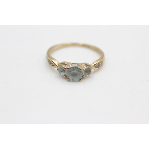 70 - A 9ct gold topaz three stone ring with diamond accents, size N½ - approx. gross weight 1.7 grams