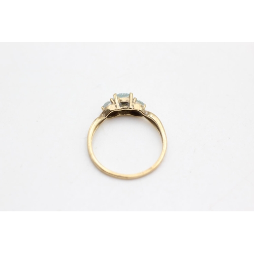 70 - A 9ct gold topaz three stone ring with diamond accents, size N½ - approx. gross weight 1.7 grams