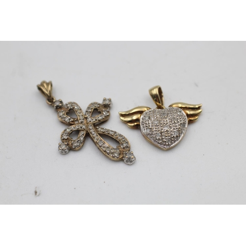 86 - Two 9ct gold diamond cluster pendants, one cross and one winged heart - approx. gross weight 3.6 gra... 