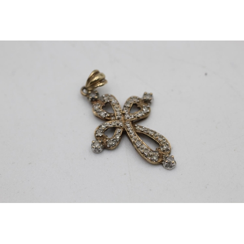 86 - Two 9ct gold diamond cluster pendants, one cross and one winged heart - approx. gross weight 3.6 gra... 