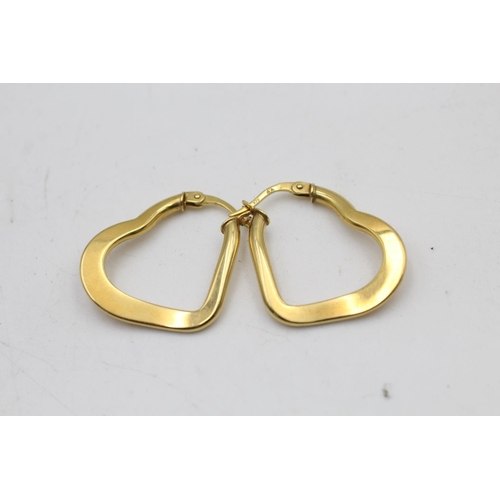 93 - A pair of 9ct gold heart shaped hoop earrings - approx. gross weight 3.8 grams