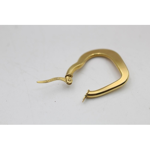 93 - A pair of 9ct gold heart shaped hoop earrings - approx. gross weight 3.8 grams