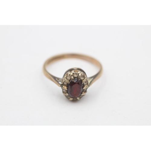 95 - A hallmarked Birmingham 9ct gold garnet and clear gemstone cluster ring, size R - approx. gross weig... 