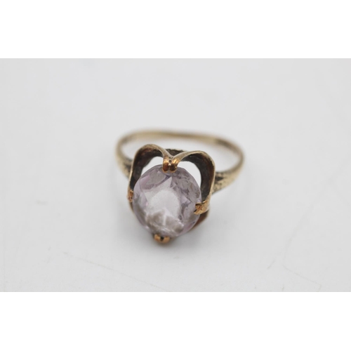 64 - Two 9ct gold gemstone solitaire cocktail rings, one amethyst size N and one paste size M - approx. g... 