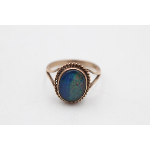 65 - A 9ct gold opal triplet solitaire bordered cocktail ring, size P½ - approx. gross weight 3.4 grams