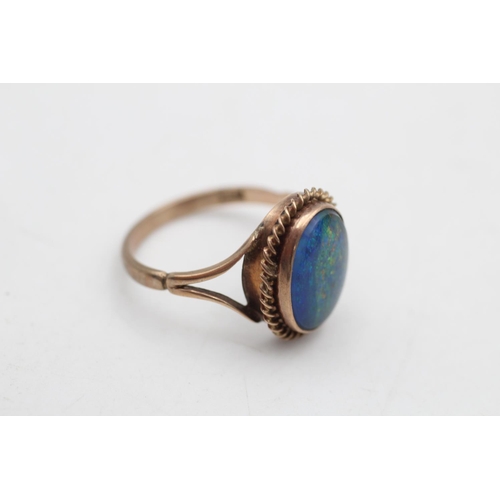 65 - A 9ct gold opal triplet solitaire bordered cocktail ring, size P½ - approx. gross weight 3.4 grams
