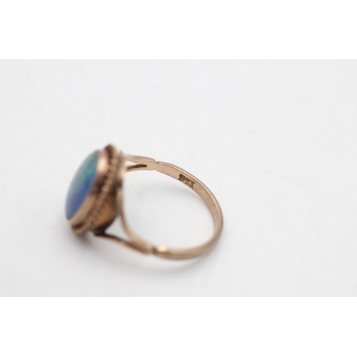 65 - A 9ct gold opal triplet solitaire bordered cocktail ring, size P½ - approx. gross weight 3.4 grams