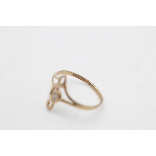 76 - A 9ct gold diamond set treble clef dress ring, size L½ - approx. gross weight 0.7 grams
