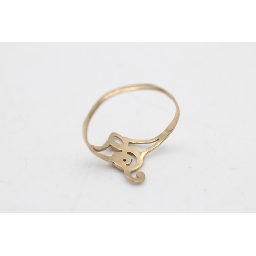 76 - A 9ct gold diamond set treble clef dress ring, size L½ - approx. gross weight 0.7 grams