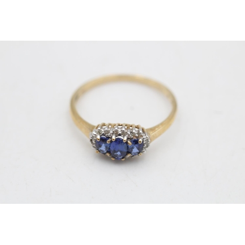 81 - A 9ct gold sapphire and diamond three stone halo dress ring, size R½ - approx. gross weight 2 grams