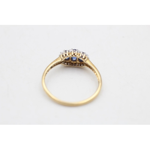 81 - A 9ct gold sapphire and diamond three stone halo dress ring, size R½ - approx. gross weight 2 grams