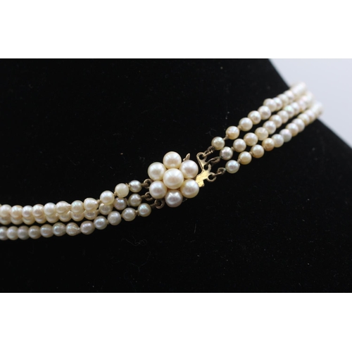 87 - A pearl three strand necklace with 9ct gold clasp - approx. gross weight 19.3 grams